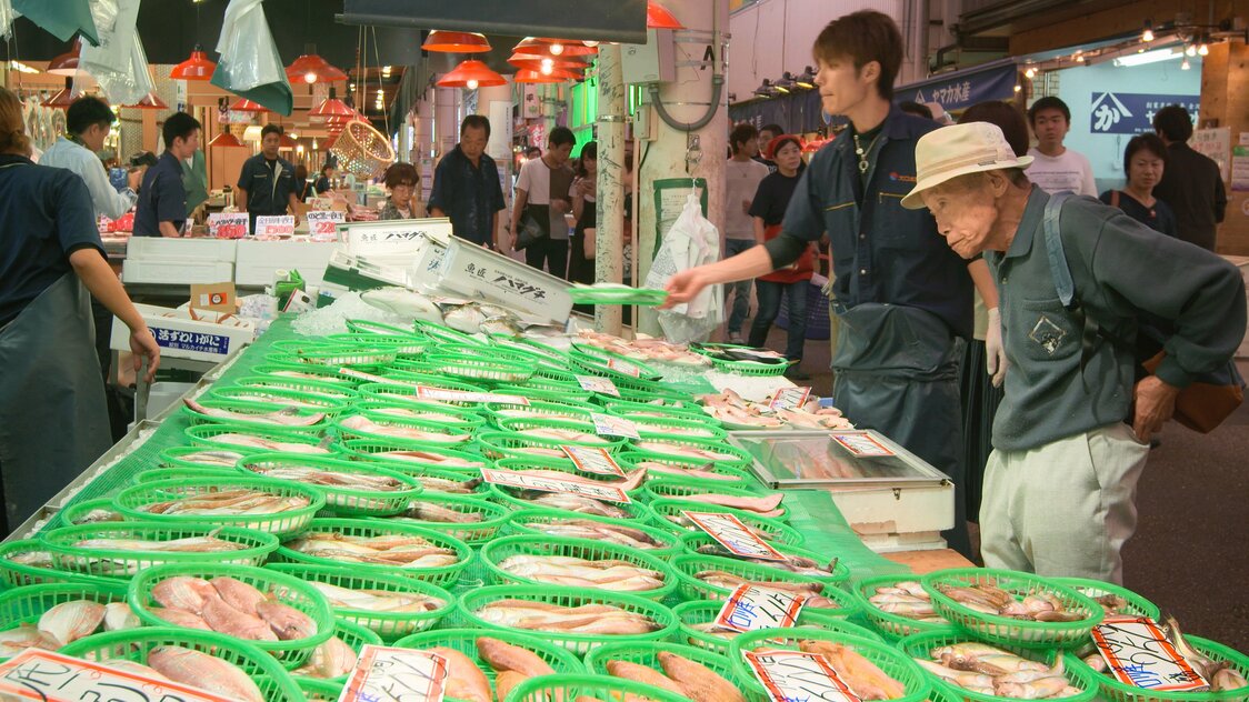 Customers eagerly wait to buy the first catch of the season.