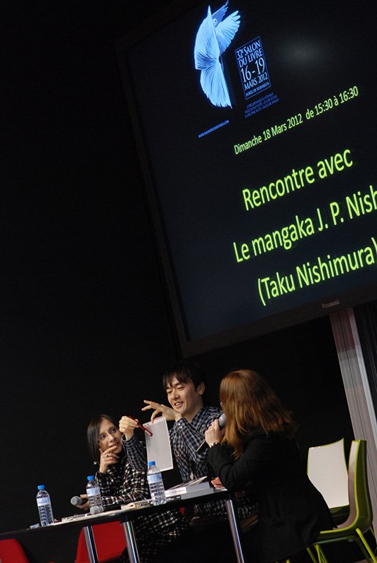 J. P. Nishi speaking at a Salon du Livre event