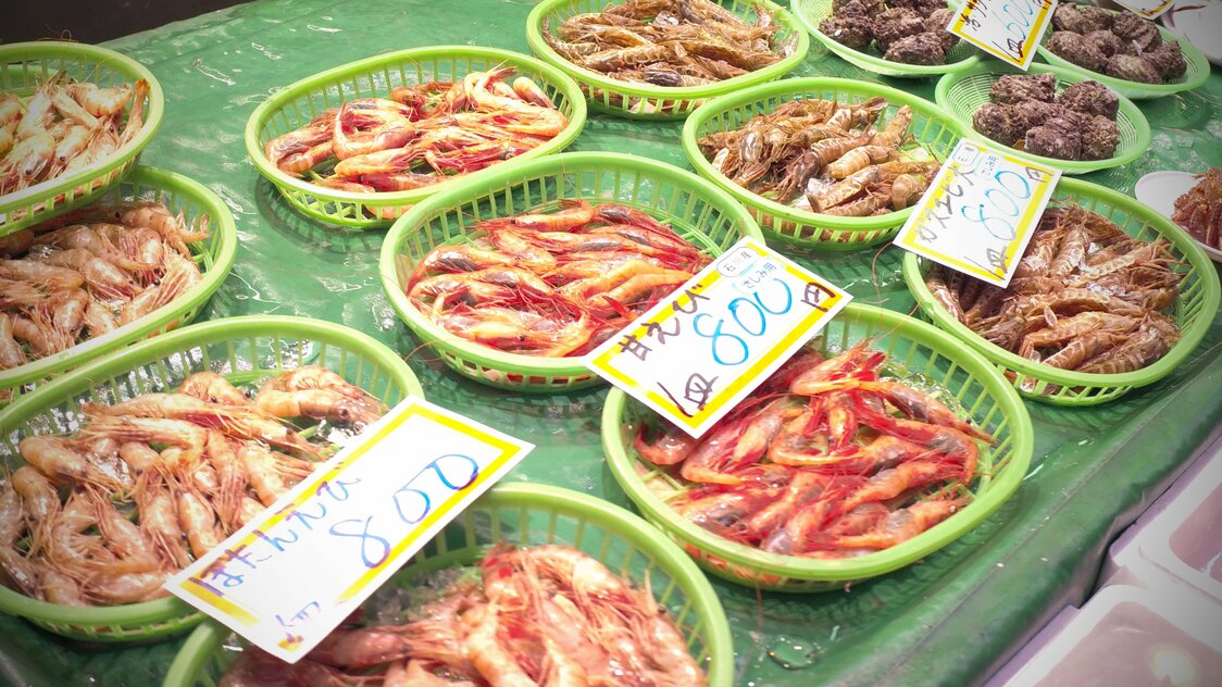 Different kinds of shrimp are laid out for sale.