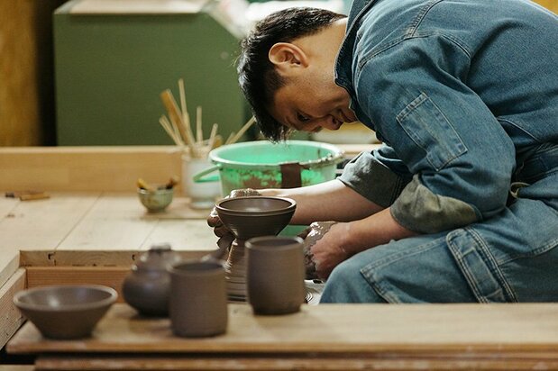 Masanori is totally absorbed as he works on the wheel.