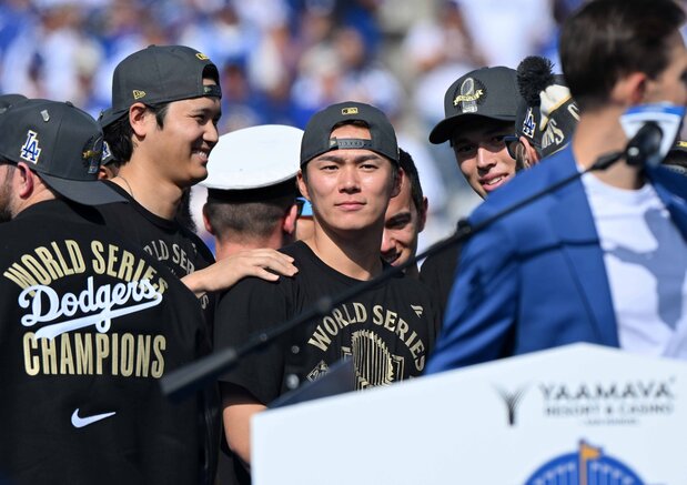 ワールドシリーズ優勝パレードを終え、本拠地ドジャースタジアムでのセレモニーで笑顔を見せる(左から)大谷翔平、山本由伸、佐々木朗希=2025年11月3日、米ロサンゼルス(時事)