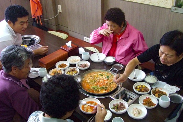 Older residents enjoying a meal donated by a restaurant.