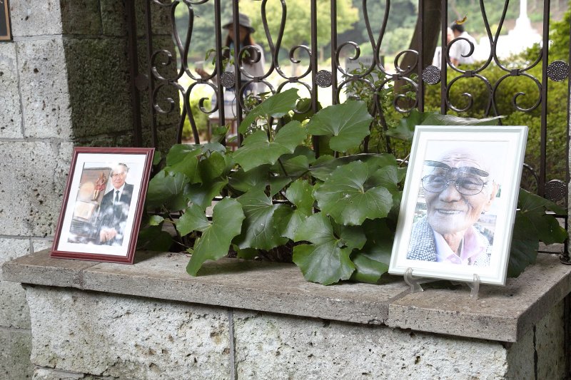 Photos of Saitō (left) and Nagase (right), now deceased, were placed at the war cemetery during the memorial service.