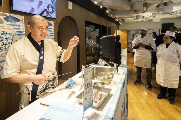 Murata Hiroshi, left, demonstrates correct slicing technique.