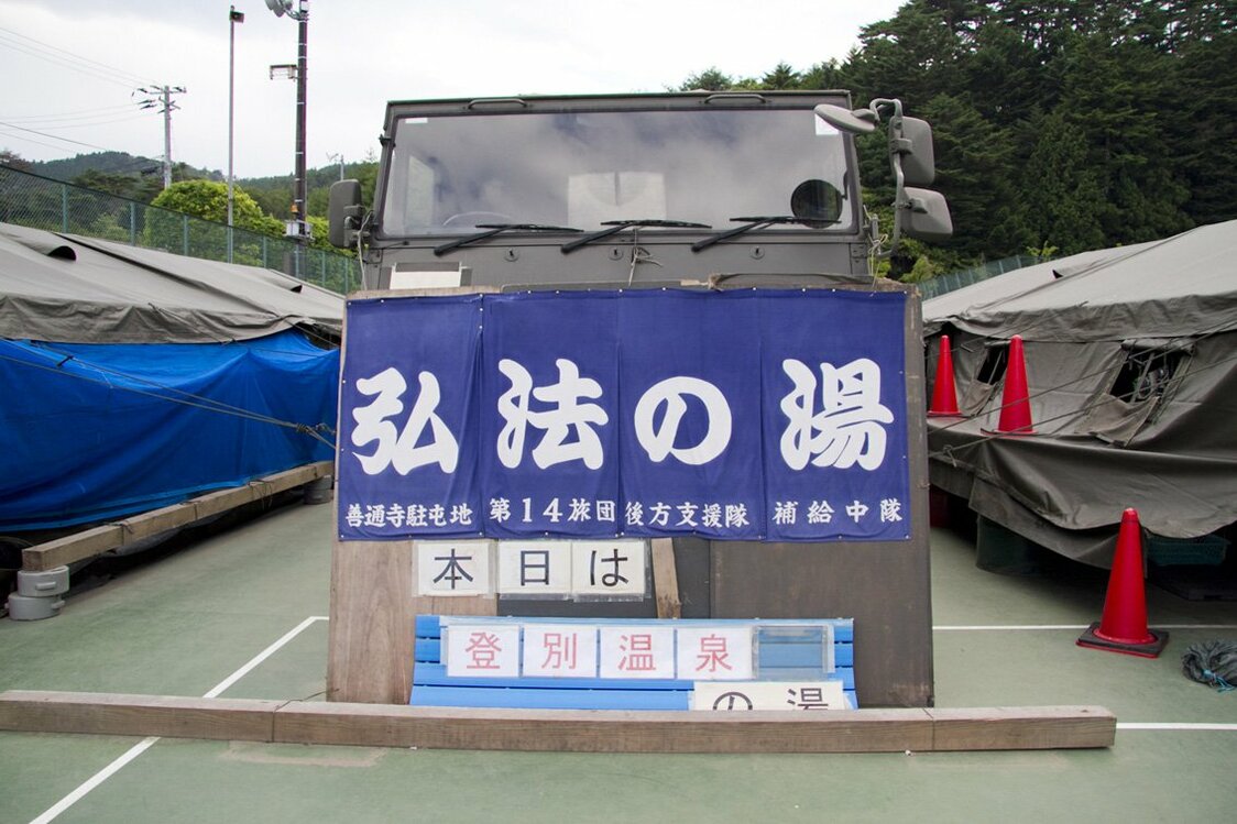 自卫队进行的洗浴支援，其设置的“弘法温泉之水”令人们心神得到慰籍。