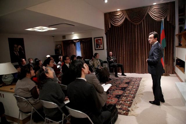 The Azerbaijani ambassador gives a talk to tea party guests at his embassy.