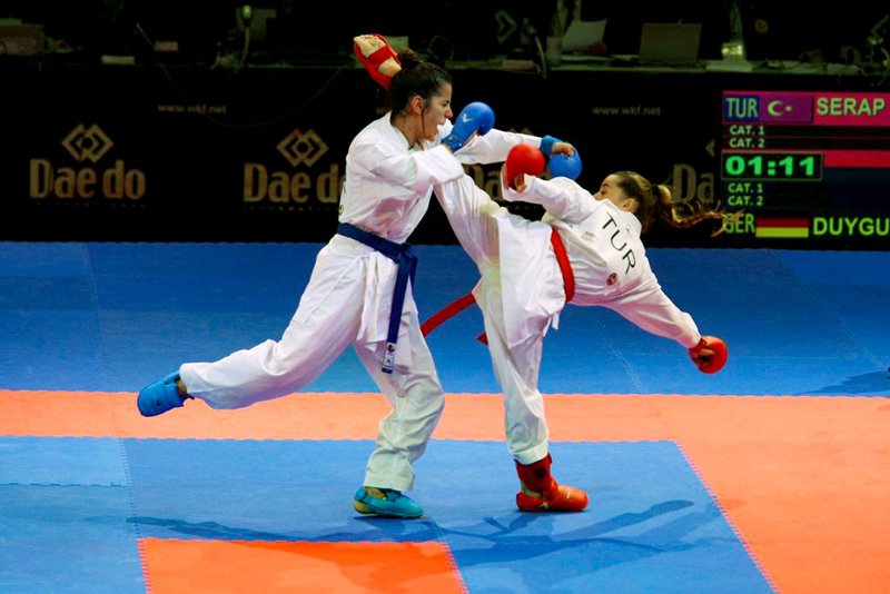 A Turkish karateka (right) launches a kick.