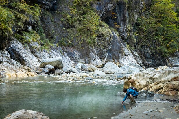 Steam rises from the riverbank near Kanetsuri Station. The hot spring is a great place for an impromptu foot bath.