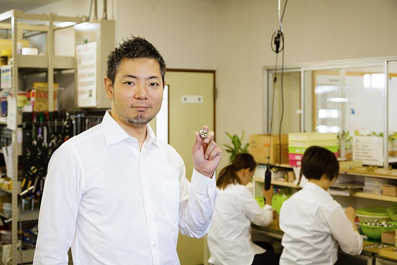 President Takano holds a Bubble90 nozzle.