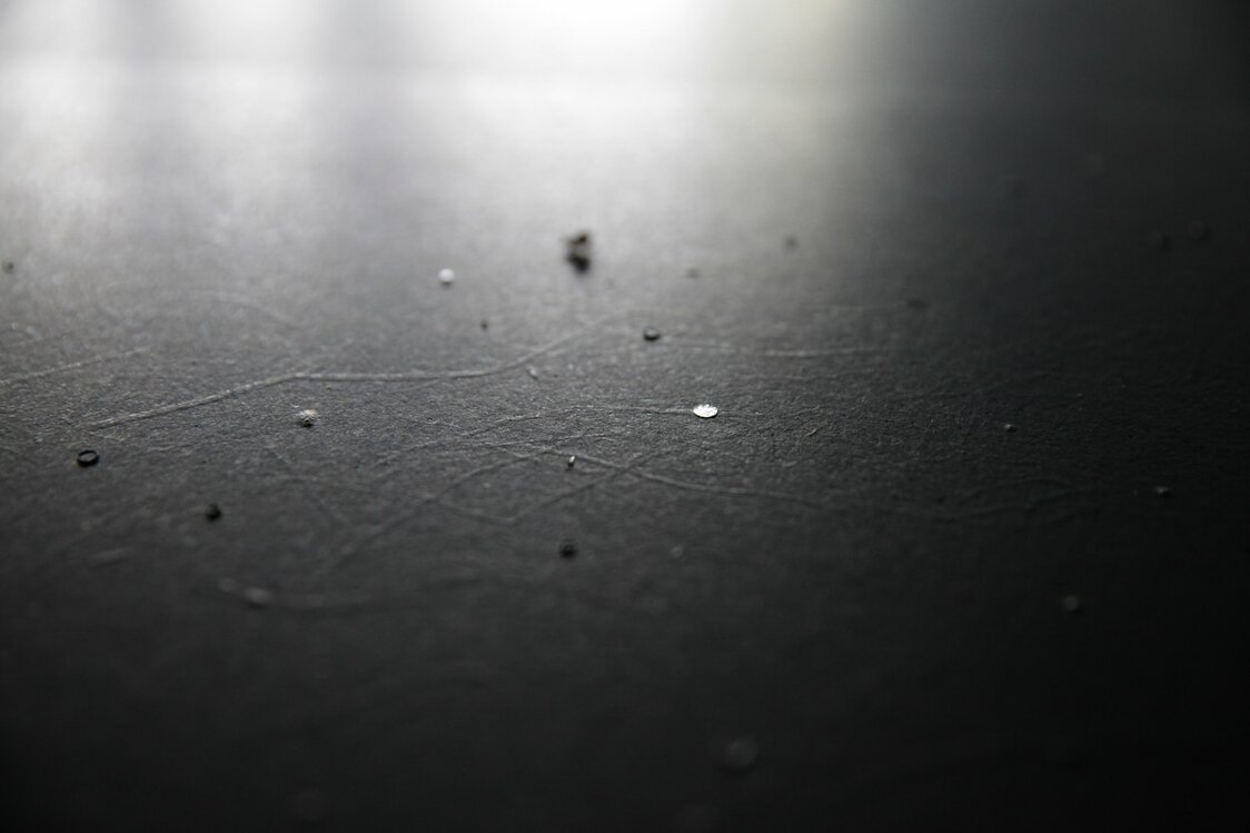 Silver leaf is applied to ganpi paper blackened with pine-soot ink. (Photo courtesy of Yamaguchi Kazuya)