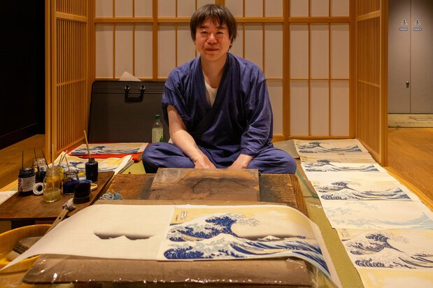 父に師事して摺師になった鉄井裕和さん。入魂の摺りに拍手が湧き起った