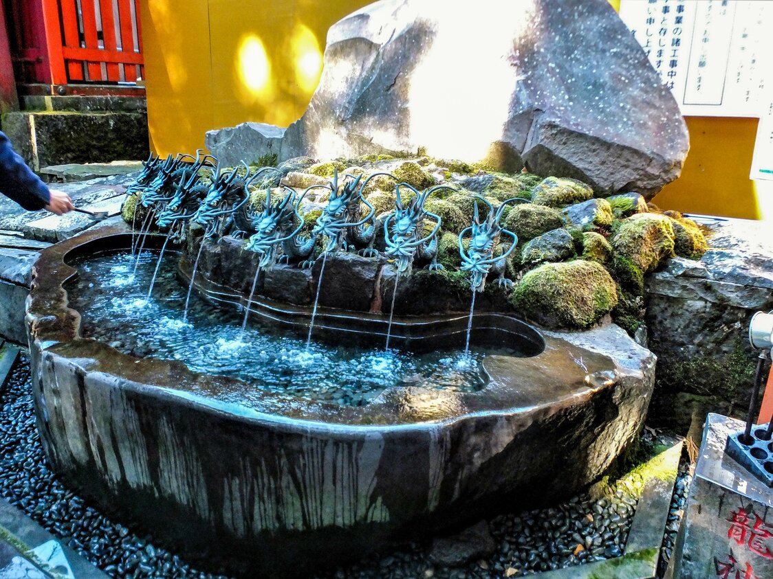新宫前的水池。九条龙口中涌出的“龙神水”，是净化不洁之物的圣水（笔者拍摄）