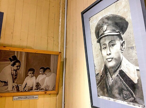 記念館となっているアウンサン将軍の旧宅に飾られた肖像画(右)と家族の写真。写真中央の子どもスー・チー氏=ヤンゴン市内、野嶋写す