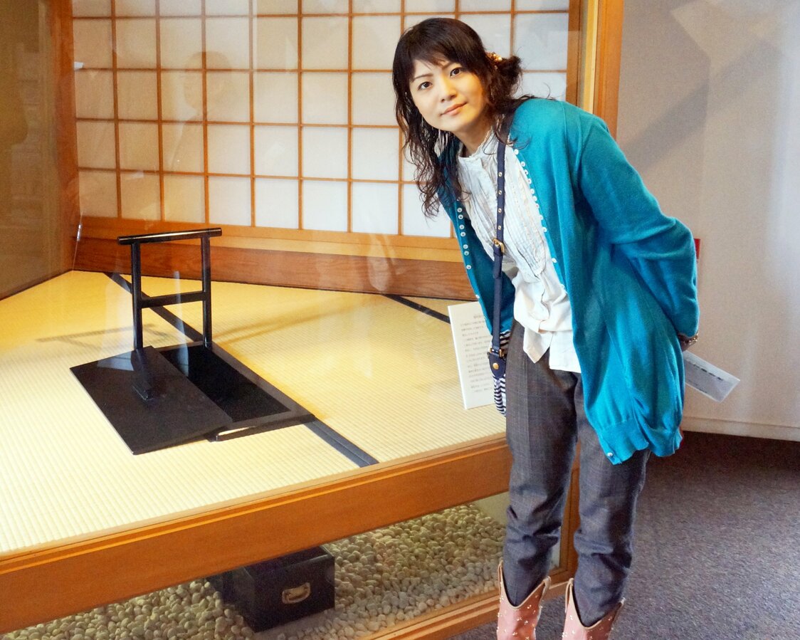 The author with a hibako. This particular pot, used by members of the upper classes, was designed so that servants could discard the waste from under the floor.