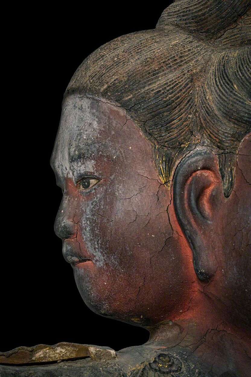 The bitten lower lip of the face on the figure’s left side (as observed) suggests a youth confronting inner turmoil.